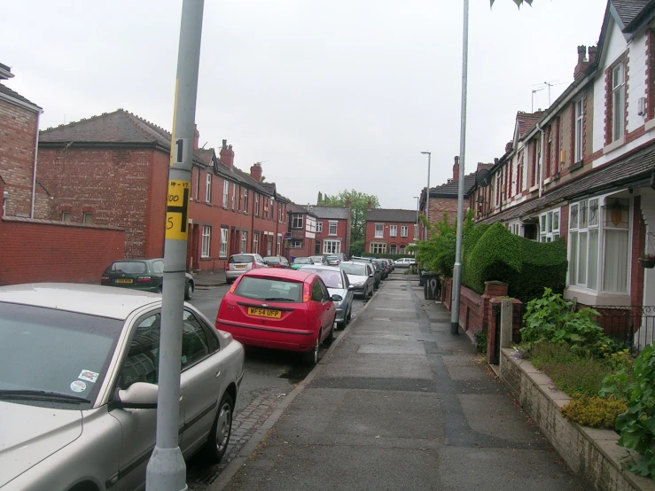 parked cars lining the side walk in a residential area