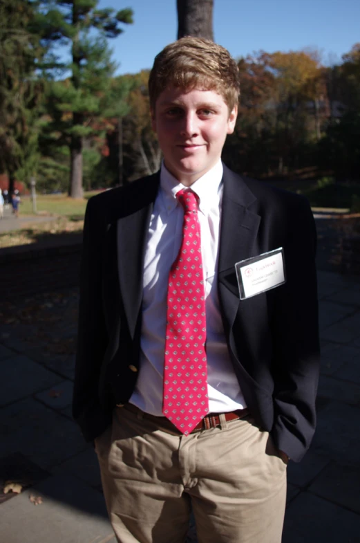 a man with a tie is posing for the camera