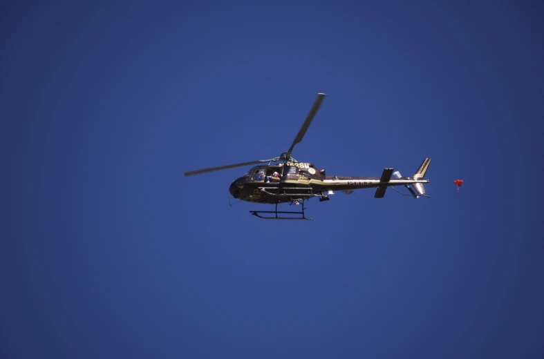 a helicopter flying in a clear blue sky