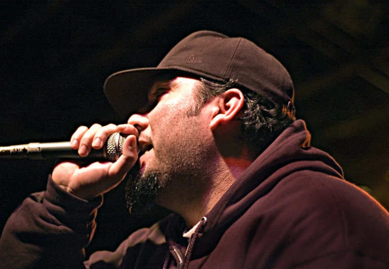 a male in a red jacket a microphone and a mic