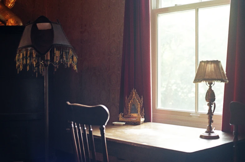 a table with two lamps on it next to a window