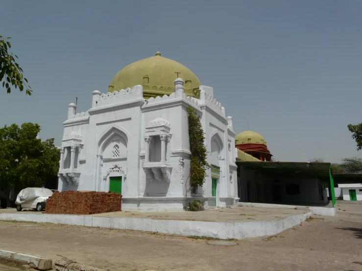 there is a large white building with a green door and window