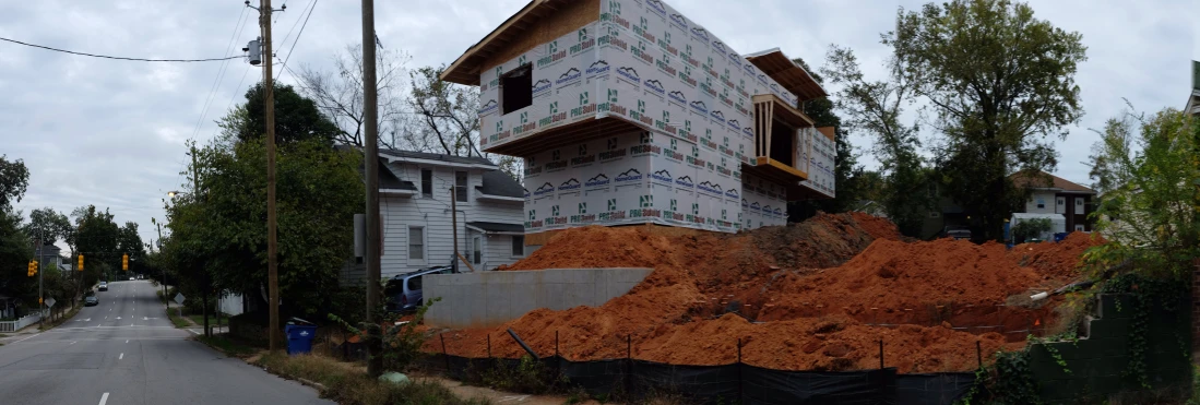 a pile of orange construction rubble along a street