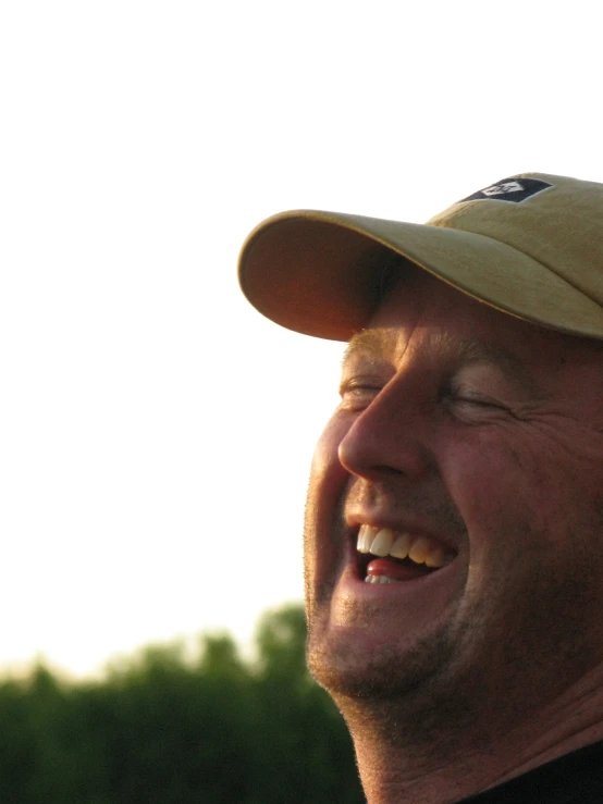 a man smiles at the camera with a big smile