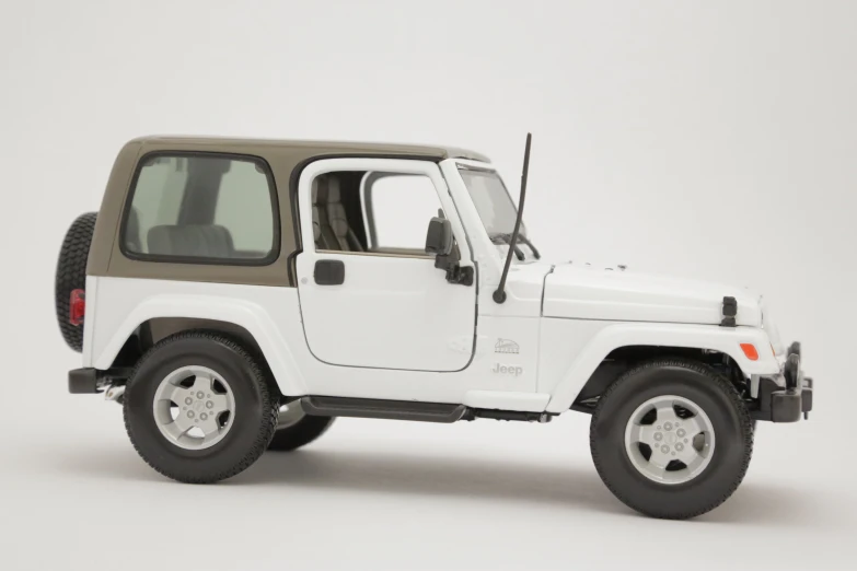 a white jeep parked on top of a gray floor