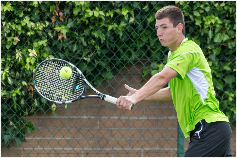 a man swinging a tennis racket at a ball