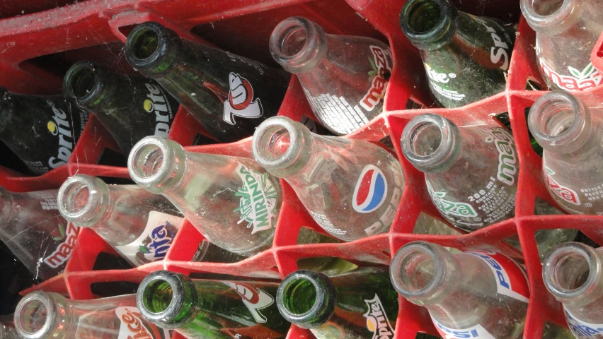 a pile of many bottles in a cooler