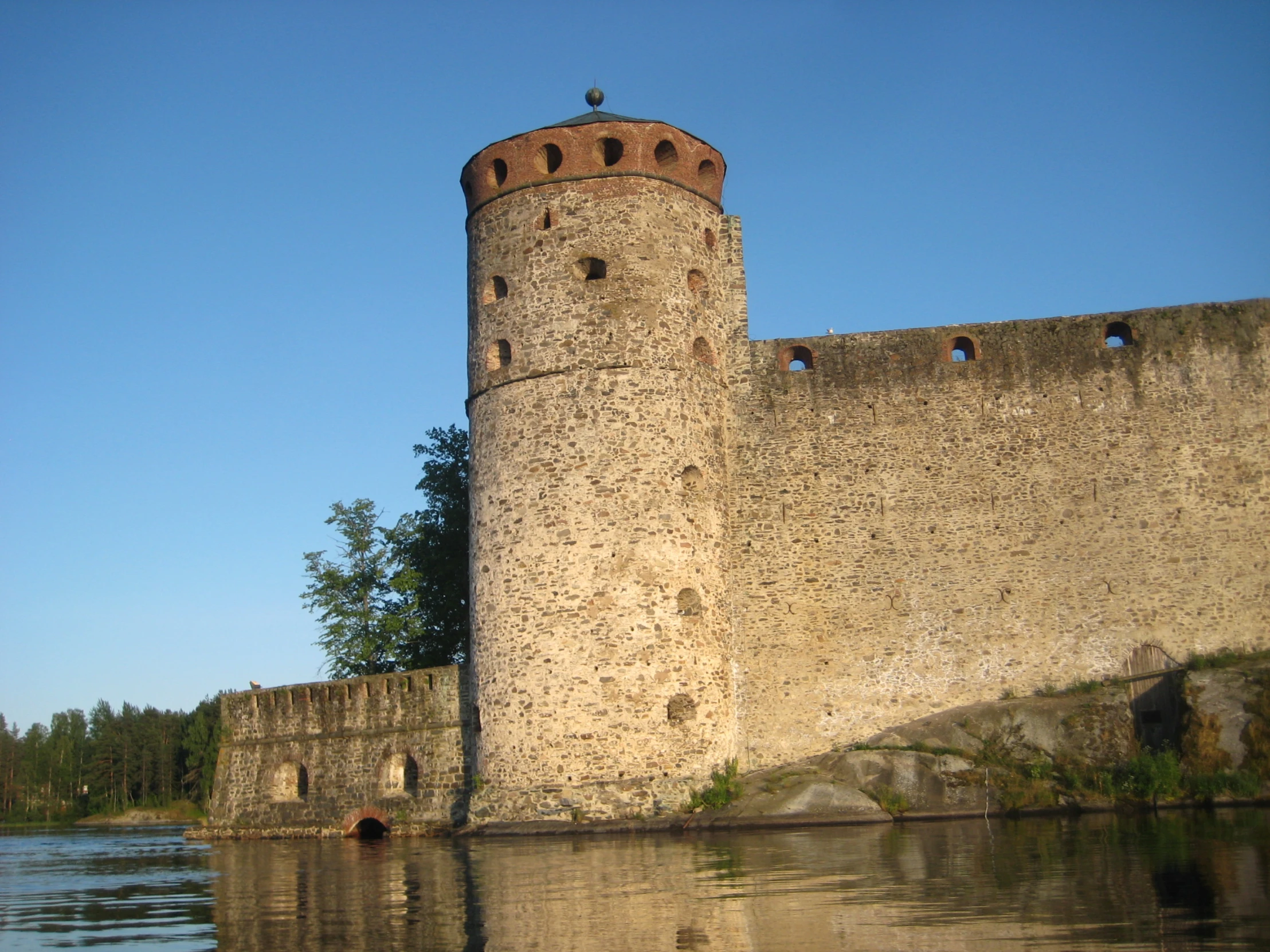 an old castle next to a body of water