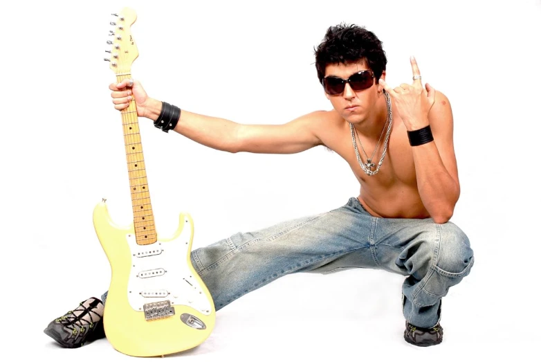 a man in sunglasses poses with his guitar