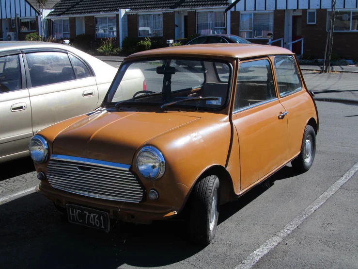 a car in a parking lot near another one in a town