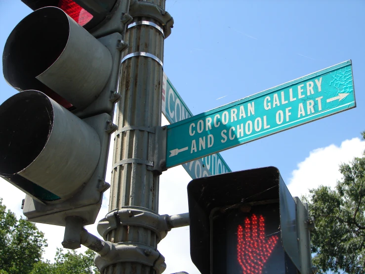 traffic lights and street signs in front of trees