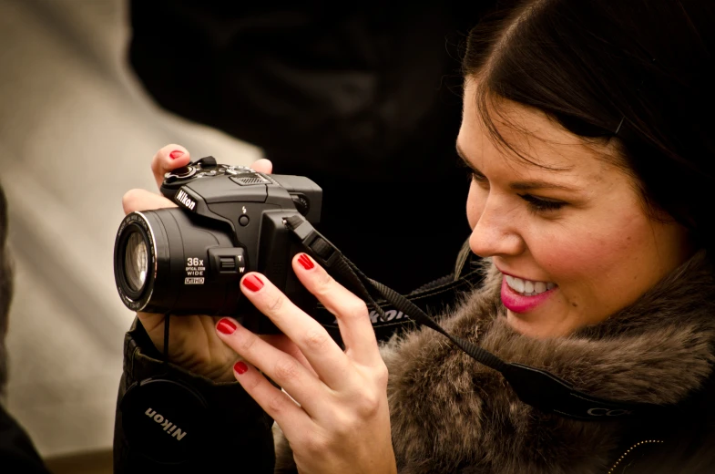 a lady holding a camera taking a picture