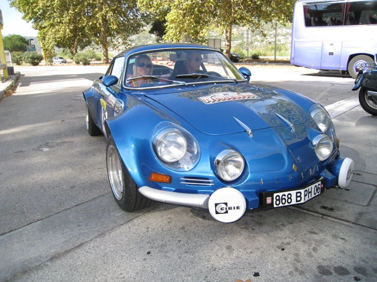 a close up of an old fashioned blue sports car