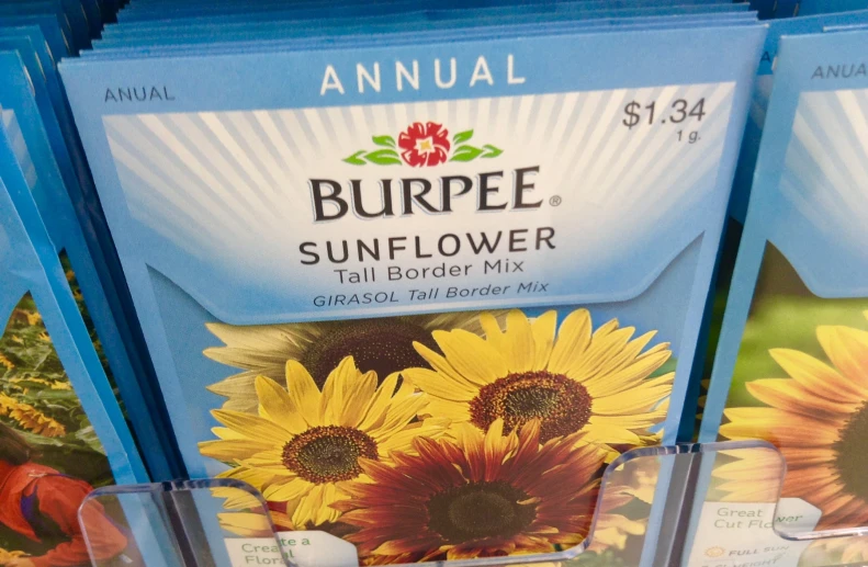 several packages of sunflower are stacked together on a shelf