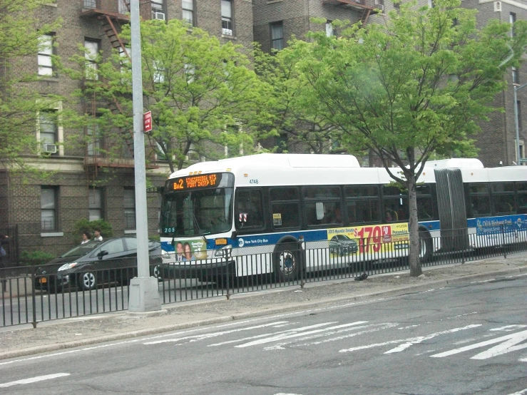 a city bus parked in front of a tall building