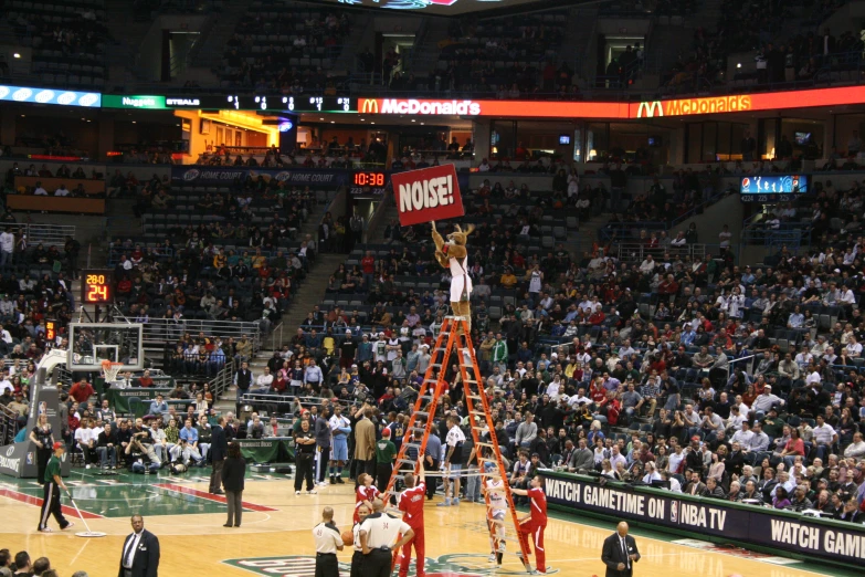 a couple of men on top of a basketball court