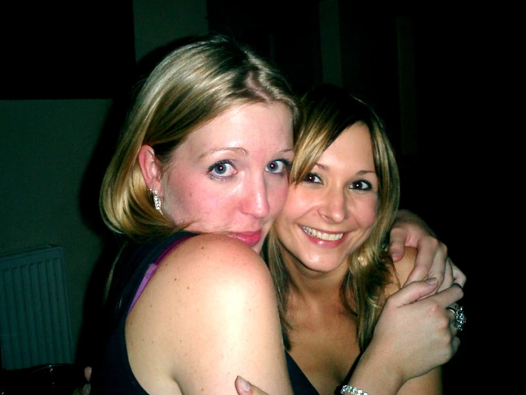 two women hugging and posing for a picture