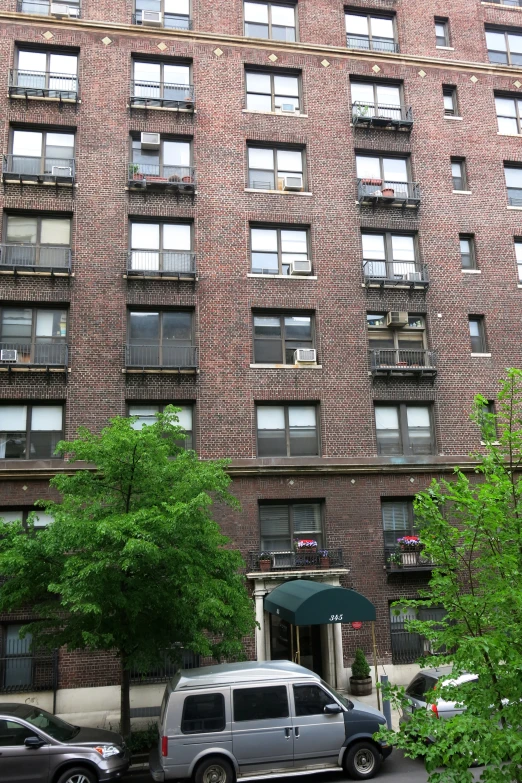 an apartment building, showing multiple stories and several windows