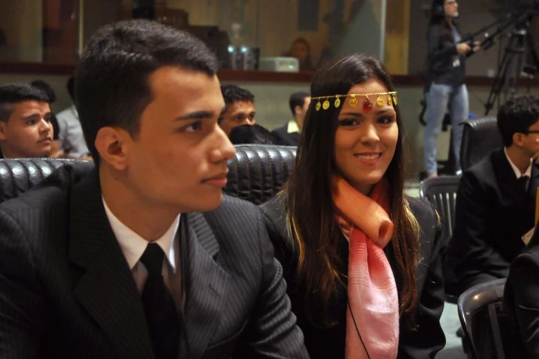 two people with bandanas in an auditorium