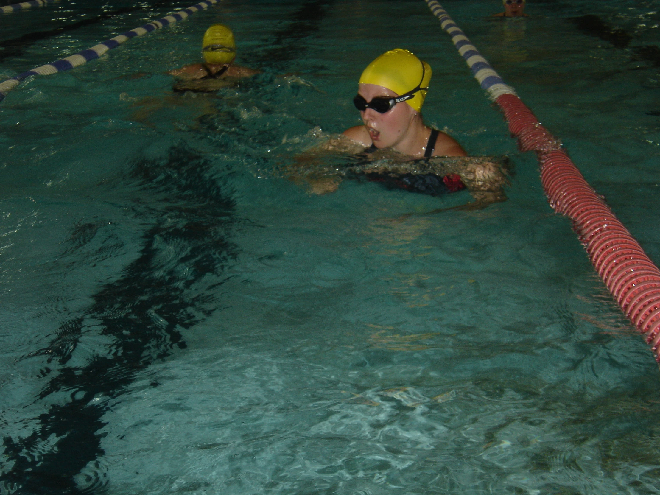 a group of people in the water next to a swimming board