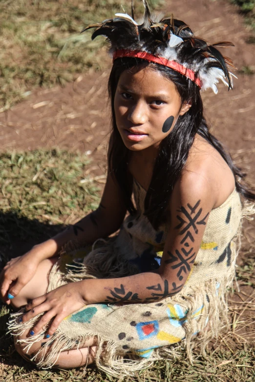 an image of a native american girl with feathers on her head