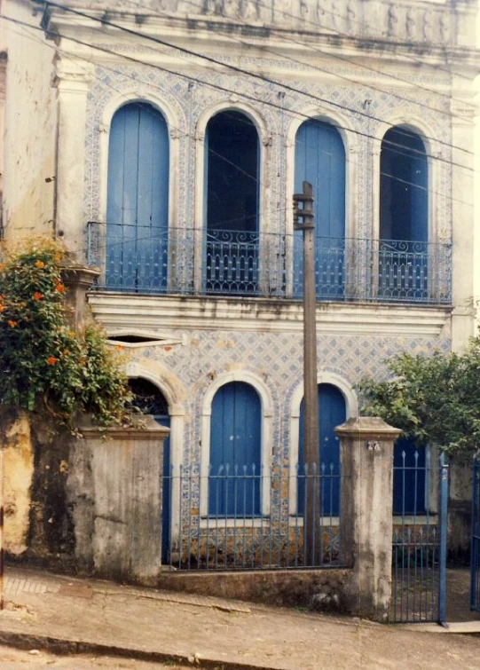 an old blue and white building has ornate detailing