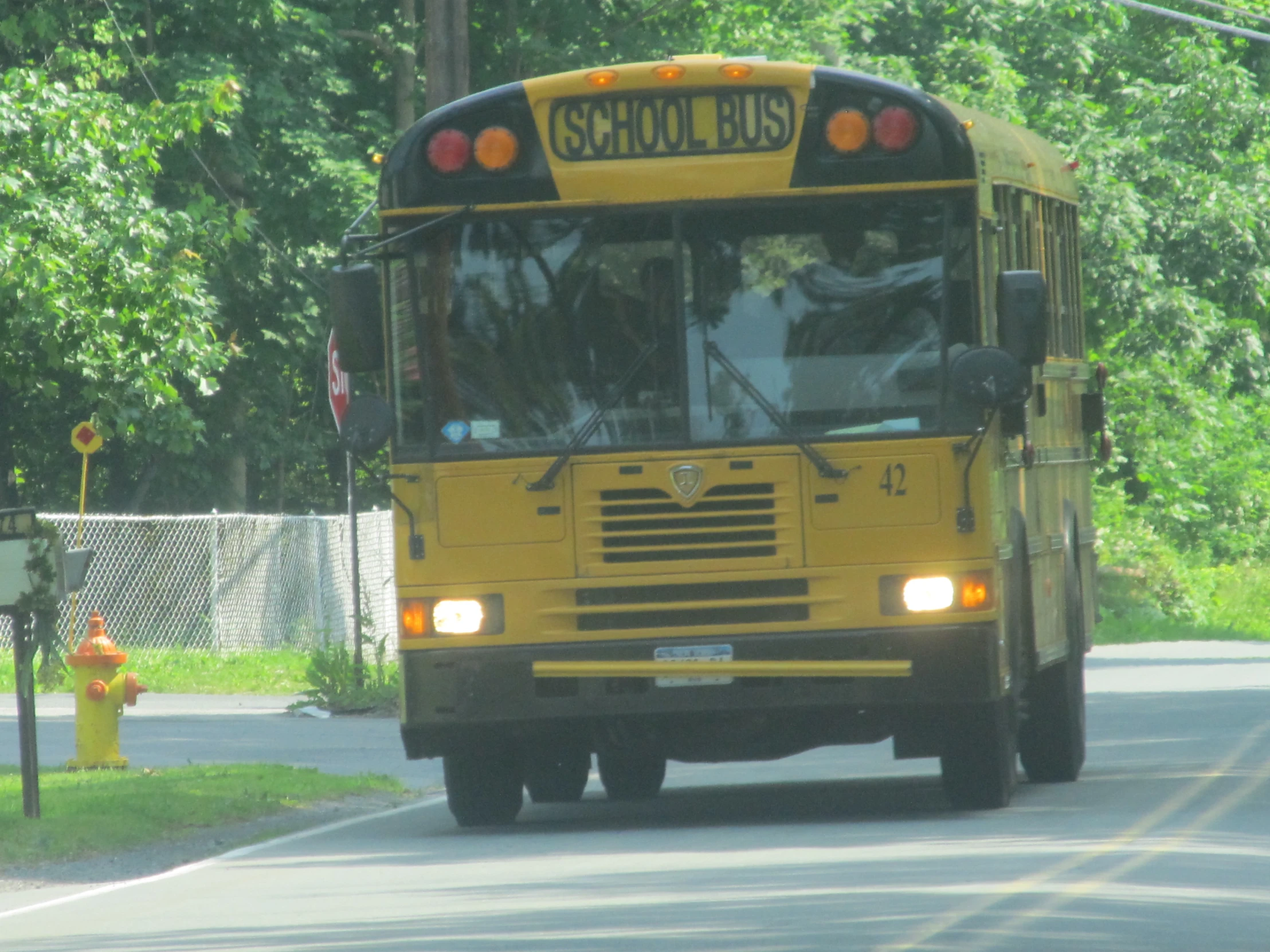 a school bus moving down the road in traffic