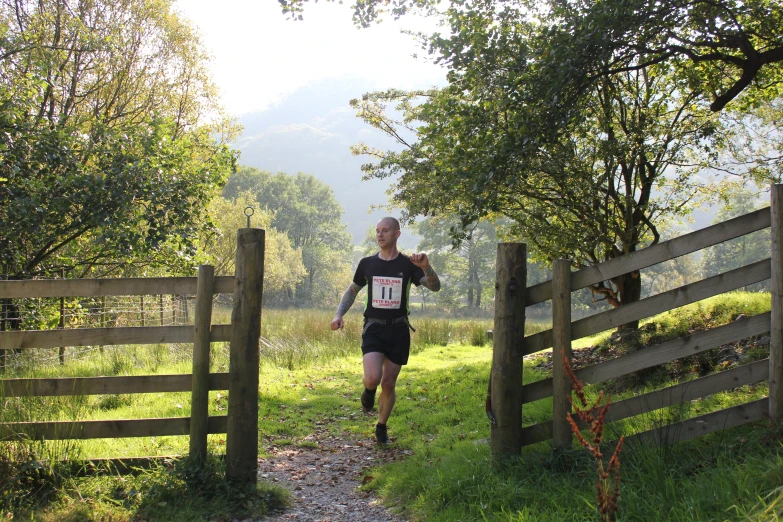 a person in a cross country trail runs across the grass