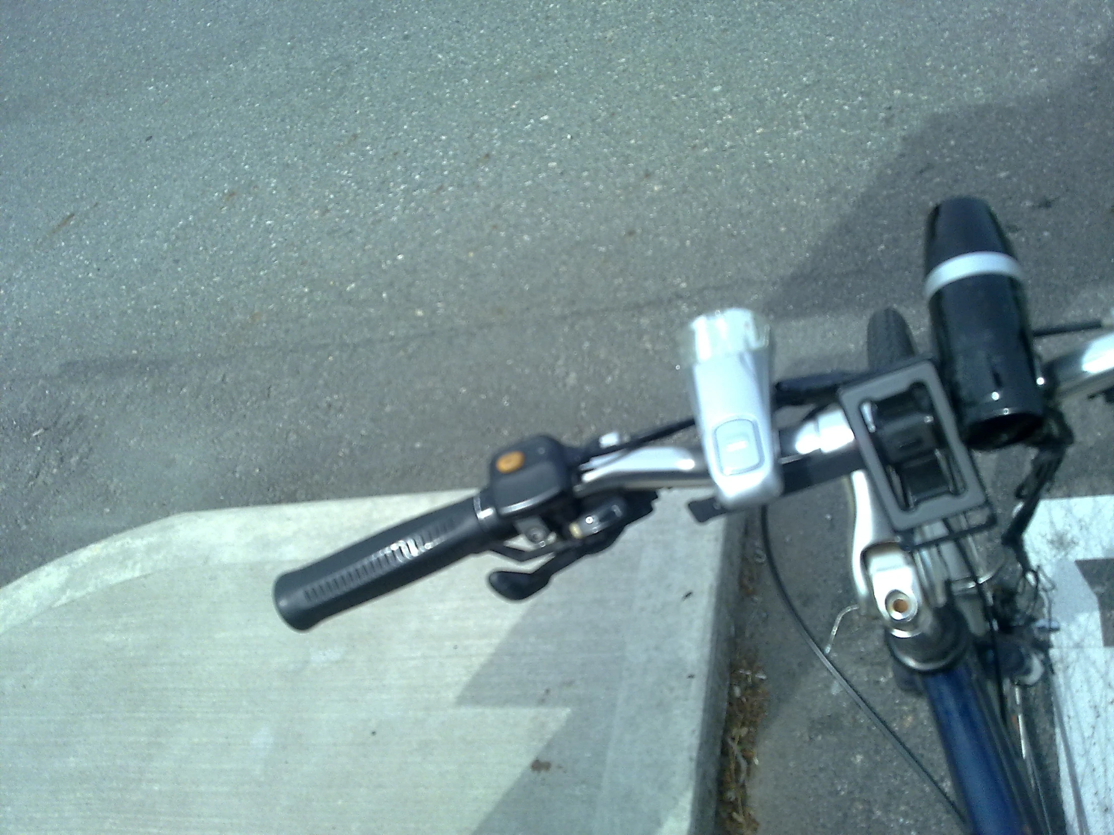 a bike parked in the parking lot near an empty road