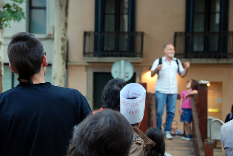 a man with a microphone gives a presentation to people