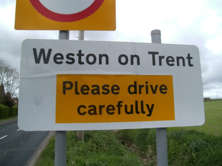 a street sign that says, weton on trent please drive carefully