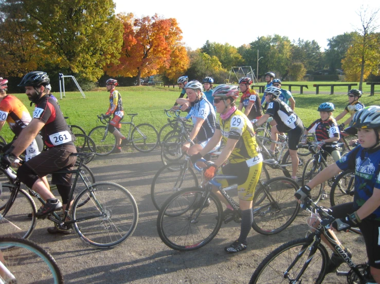 a group of people riding bikes on a dirt road