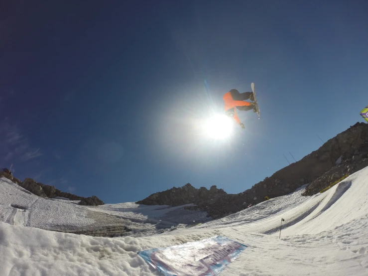 snowboarder doing a jump at the bottom of a snowy mountain