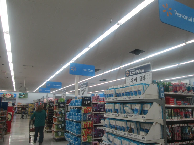 the people are walking through the store, all looking to the right