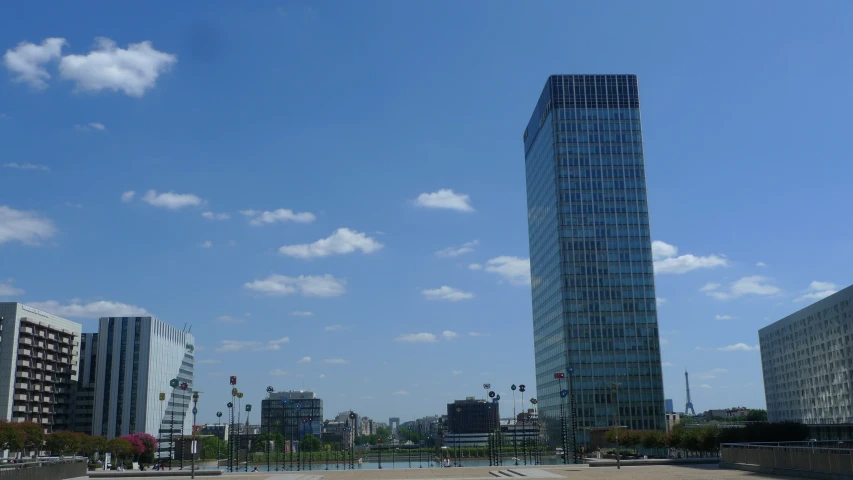 a tall building is seen near a busy street