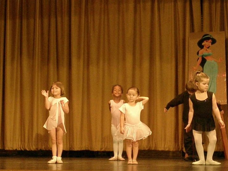 five little girls are dressed up as ballet costumes