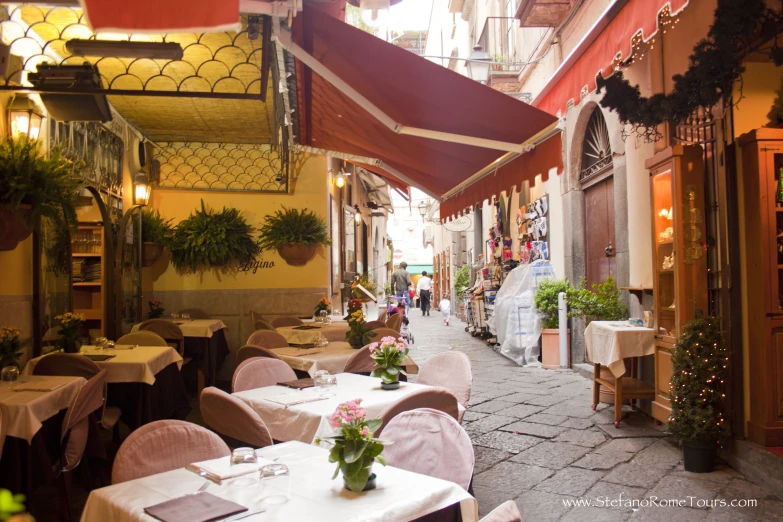 an outdoor restaurant with many tables set up