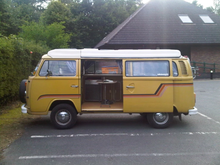 an old van is parked in a lot near some bushes