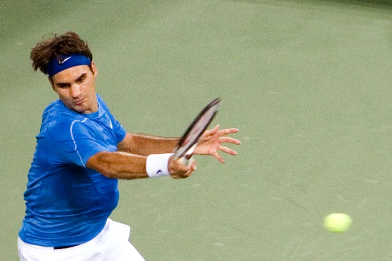 a male tennis player hitting a ball during a game