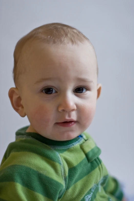 a very cute little boy with a funny look on his face