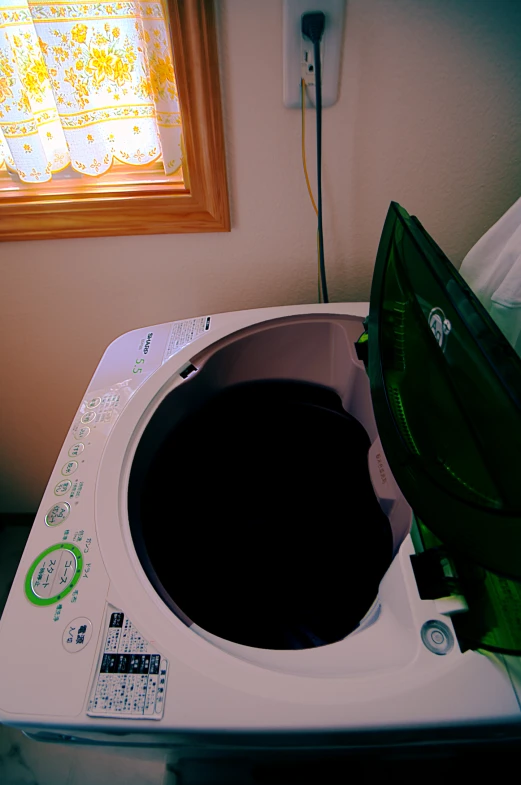 a black liquid in a white machine with an umbrella on it