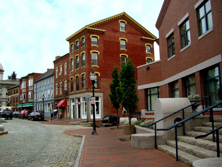 the street is lined with brick buildings on both sides