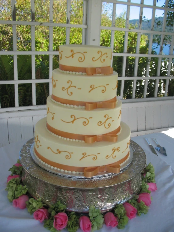 a four layer cake with brown ribbons