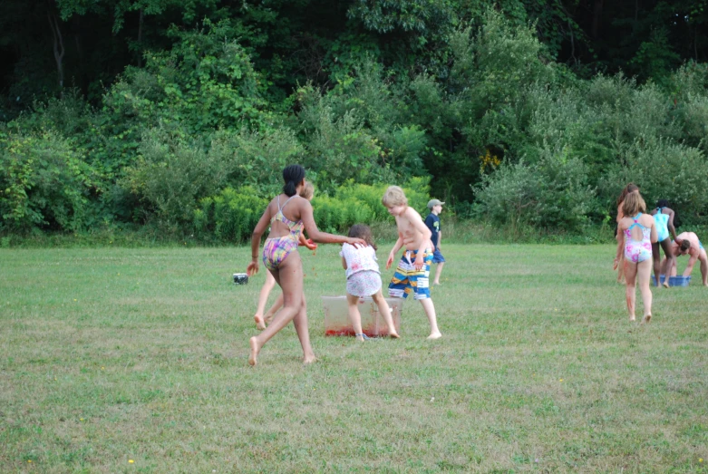 group of people on grassy field playing with ball