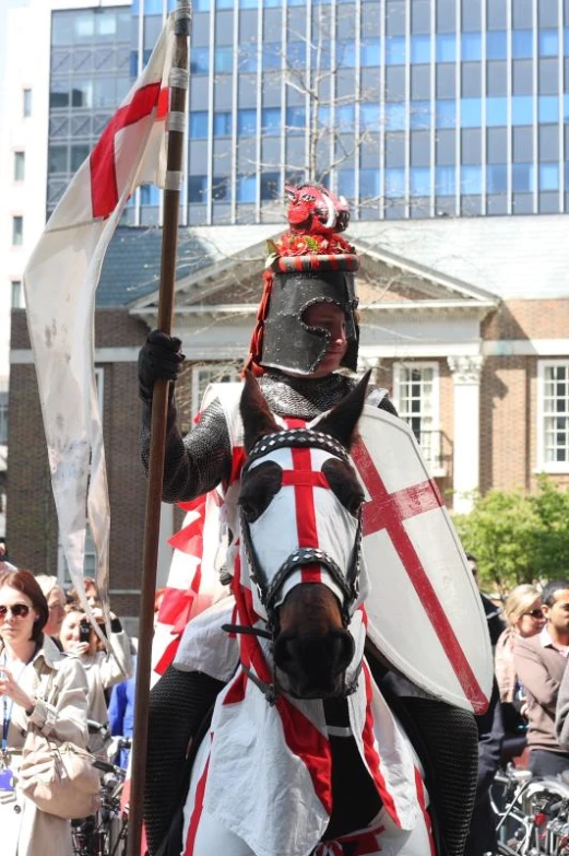 a man in armor rides down a city street