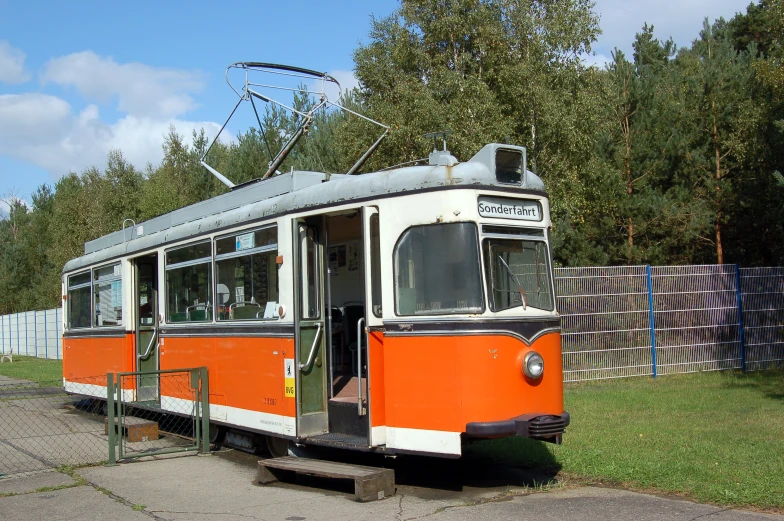 an old trolley that has just come out of the station