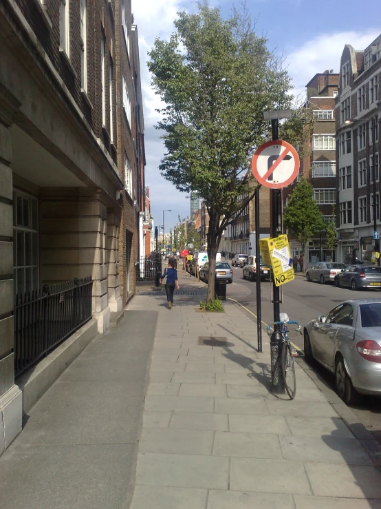 a road with several cars and pedestrians driving down it