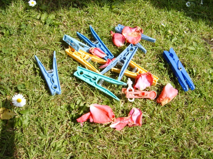 toy tools scattered around in a pile on the grass