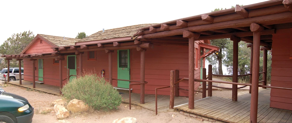 an old red building with lots of green doors