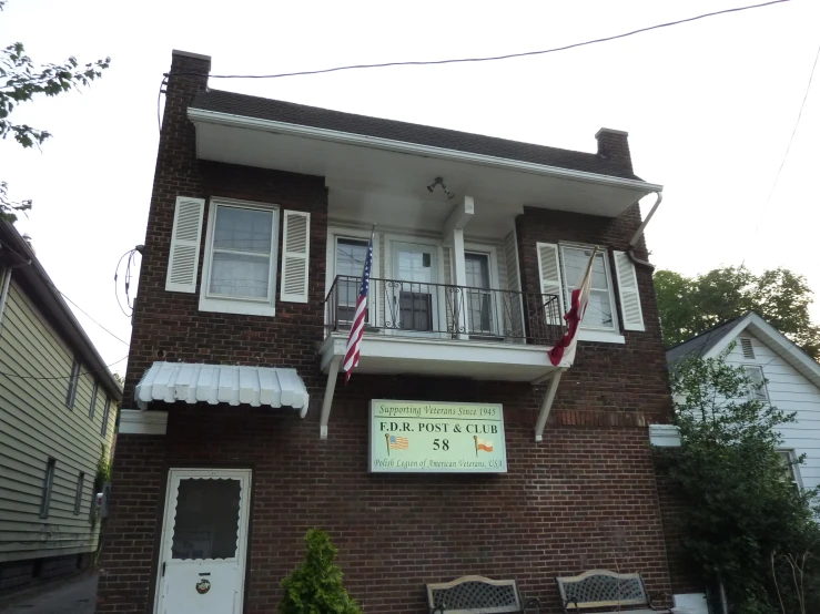 an image of a brown brick building with a large sign on it